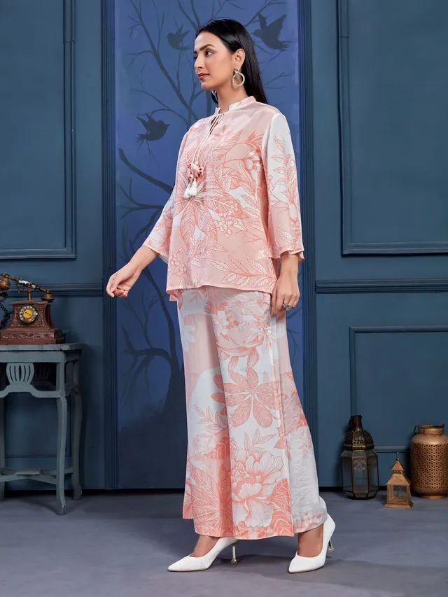 stylish monochromatic floral printed pure viscose natural crepe flare sleeves and mandarin collar neck tie-up drawstrings with tessels top pared with comfortable flare pants set - Peach
